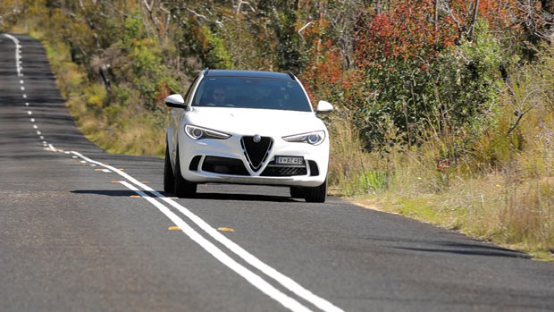 2021 Alfa Romeo Stelvio Quadrifoglio SUV white exterior front 3/4 driving shot 1